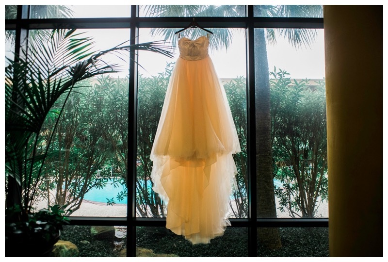 Wedding gown by David's Bridal hung in the window of MCM Elegante Hotel